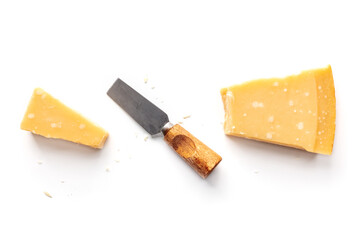 Parmesan cheese wedge, cut, with a cheese knife, isolated on a white background, overhead flat lay shot