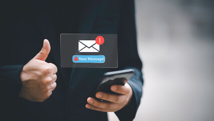 Businessman touching new message notification icon on virtual screen,email alert, online messaging system, representing digital communication, instant response, and business connectivity.