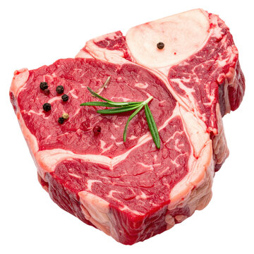 Fresh raw chulet&oacute;n de buey beef chop with rosemary and black peppercorns close-up view isolated white background
