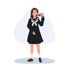 a girl in school uniform holding a camera. A smiling young girl in sailor suit with a camera. Japanese school girl.