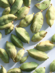 Vibrant green cardamom pods scattered artfully, showcasing natural texture and aromatic spice for culinary inspiration and health benefits.