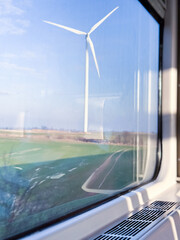Wind Turbine Through the Window &ndash; A Modern Countryside Scene