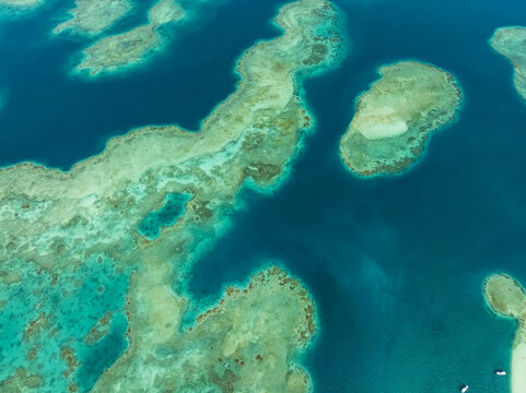 Aerial view of turquoise waters embrace the sandy shores, creating a mesmerizing coastal mosaic of vibrant hues, Progreso, Yucatan, Mexico.