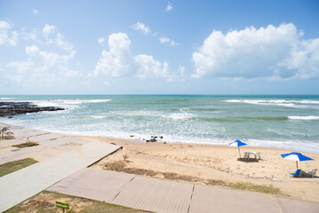 Tropical Beach with Colorful Umbrellas under a Blue Sky