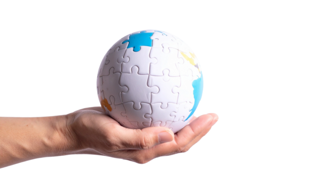 A hand holding a globe puzzle representing the world, the concept of puzzle, the concept of holding and the concept of global 