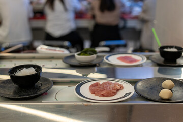 Raw Chicken Slices on Plate at Shabu-Shabu Conveyor Belt Restaurant