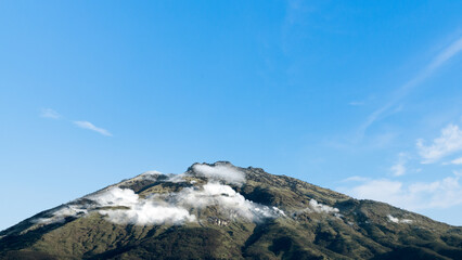 Landscape view of mountain with cloudscapes against blue sky background. Natural background. Concept of travel
