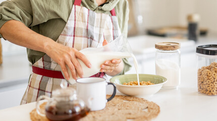 Woman Pouring Milk Into Cereal