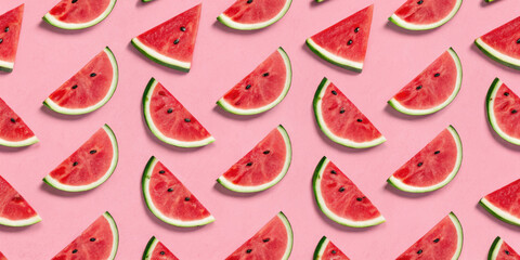 Slices of juicy watermelon arranged in pattern on pink background create vibrant and refreshing summer vibe