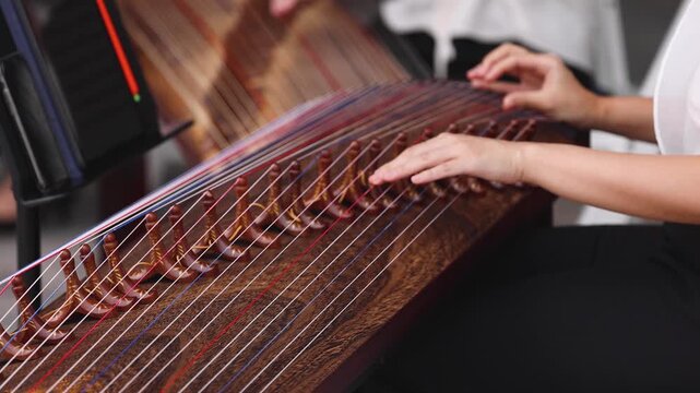 Traditional Korean folk musical instrument Gayageum, female orchestra band performing concert on Kayagum in of Seoul, South Korea, wooden zither with 12 strings, Koto or Guzheng live music performance
