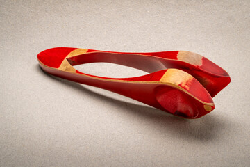 Wooden musical spoons, folk percussion instrument on textured paper