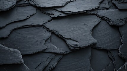 Close up of overlapping dark gray slate roof tiles texture