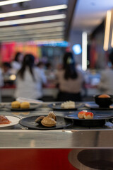 Stuffed Fish Balls with Crab Roe on Plate at Shabu-Shabu Conveyor Belt Restaurant