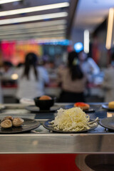 Shredded Cabbage on Plate at Shabu-Shabu Conveyor Belt Restaurant