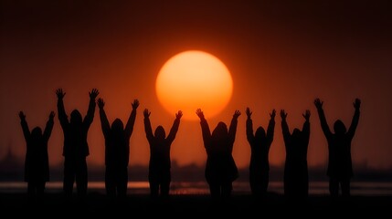 Fototapeta premium Silhouetted figures raise their hands in celebration against a vibrant sunset sky creating a sense of unity hope and aweinspiring natural beauty