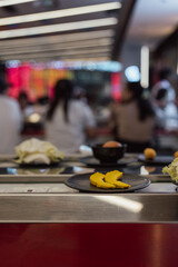 Pumpkin Slices on Plate at Shabu-Shabu Conveyor Belt Restaurant