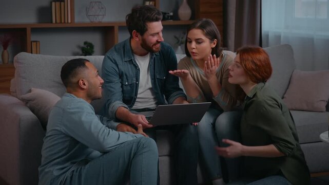 Four diversity ethnic friends with laptop smiling happy communicate at home party multiracial people carefree discussing choosing film online internet using together booking trip order food delivery