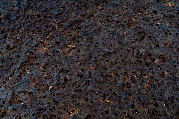 A close up of a rocky surface with holes in it