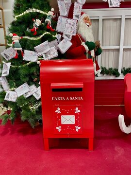 Traditional red mailbox for letters with Spanish text, symbol of communication and nostalgia.