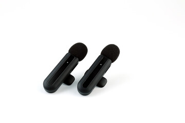 modern wireless microphone system with two clip-on transmitters and a receiver on white background, ideal for smartphone recording podcasting vlogging and professional audio production content creator