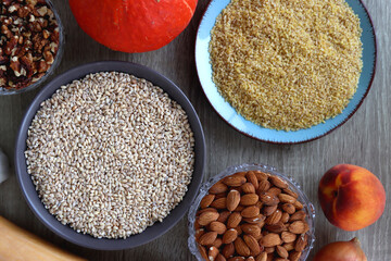 Assortment of various healthy fruits, vegetables, grains and legumes. Top view, wooden background.