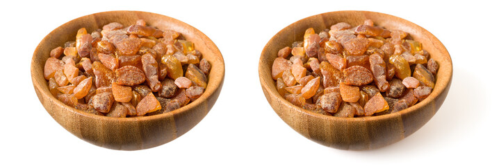 Crushed amber in the wooden bowl, isolated on white background.