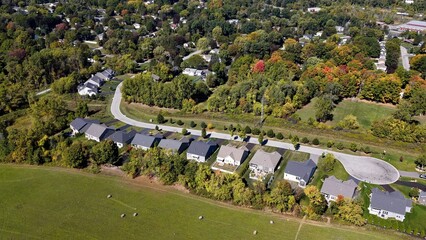 American rural neighborhood houses and homes during Autumn Fall season colors in trees with sunshine peaceful living in New York State Countryside