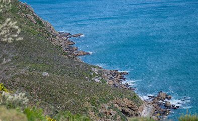 Steep cliffs and turquoise sea on the M6 Chapman's Peak Drive route in South Africa