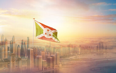 Burundi national flag aerial view clouds in beautiful sky. Top view. Drone. Aerial bird's eye fly flag. Aerial top flag view cloudscape.  Flag with Sunrise or sunset over clouds.