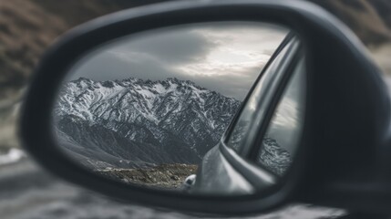 reflection in car mirror showing mountain landscape and cloudy sky, concept of journey and freedom, sharp detail, realistic texture
