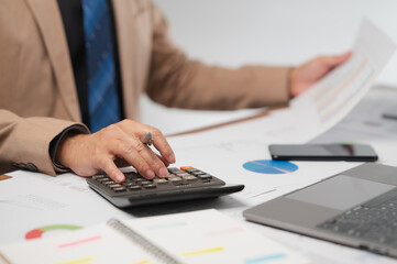 Focused Businessman Calculating Financial Data in Modern Office with Technology