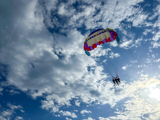 Parasailing high up in blue sky in Summer