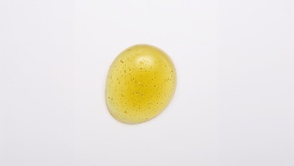 Fresh Indian gooseberry or Amla fruit oil drop with high vitamin C and mineral content, used for medicine. Believable medical idea, isolated on white background.