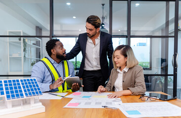team of multiethnic coworker meeting on solar roof system project with solar panel house model, responsibility of green industry alternative renewable clean environment energy for sustainable business