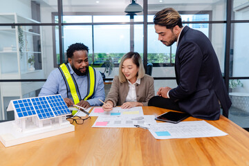 Fototapeta premium team of multiethnic coworker meeting on solar roof system project with solar panel house model, responsibility of green industry alternative renewable clean environment energy for sustainable business