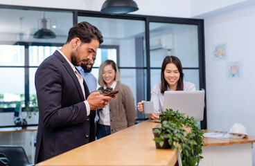 team of multiethnic colleague discuss business topic in creative green office co working space, group of business people coworker casual online meeting on laptop standing desk modern office workplace