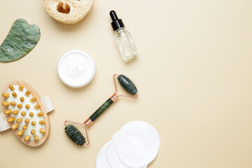 Skincare set with marble roller, gua sha, wooden body brush, facial cream and serum for natural beauty care