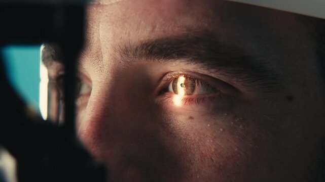 Male patient undergoing detailed vision examination with advanced ophthalmic equipment, focusing on eye health and diagnostic procedures in a clinical setting