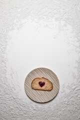Slice of Bread with Heart-Shaped Jam on Striped Plate