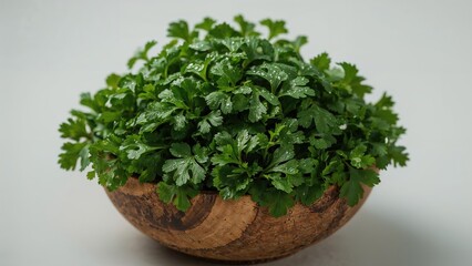 Fototapeta premium Top view of fresh coriander leaves in a wooden bowl