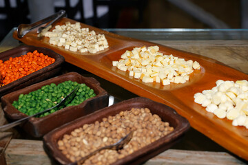 Charcuterie board with cheese cubes nuts and fresh vegetables