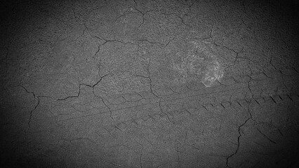 Cracked Asphalt Surface with Tire Track Imprint in Monochrome Shade