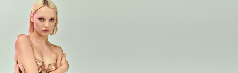 Blonde young woman poses stylishly with holographic elements in a party setting