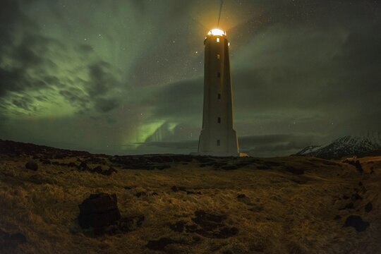 Northern lights or aurora borealis, lighthouse sends light signal, Malarríf, Snæfellsnes Peninsula, Snæfellsjökull National Park, Iceland