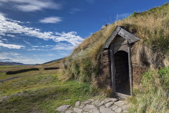 Traditional turf house with wooden door and grass roof in the sunshine, replica of a Viking longhouse, home of Eir&iacute;kr &THORN;orvaldsson or Erik the Red, Eir&iacute;kssta&eth;ir, Iceland