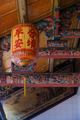 Traditional chinese lantern and ornate roof carvings at Sin Sze Si Ya Temple, the oldest chinese temple in the city of Kuala Lumpur, Malaysia.