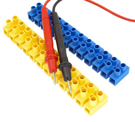 electrical terminal blocks and multimeter probes on white