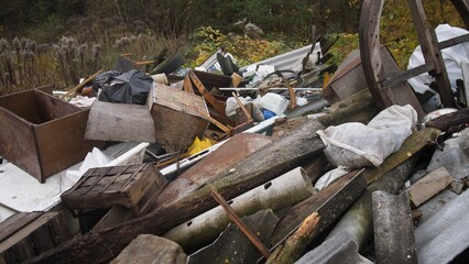 lawless and overgrown open field area, disorganized and cluttered wilderness with no clear boundaries or order, untamed and disorderly open space characterized by overgrowth and lack