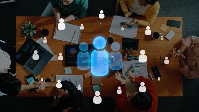 A vibrant team meeting showcasing diverse individuals engaged in discussions, brainstorming ideas, and utilizing technology for effective collaboration in a modern workspace. Raster - Powered by Adobe