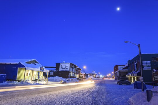 Snowy road, city, cars, buildings, cold, snow, twilight, moonlight, Arctic, Inuit settlement, Inuvik, Northwest Territories, Canada